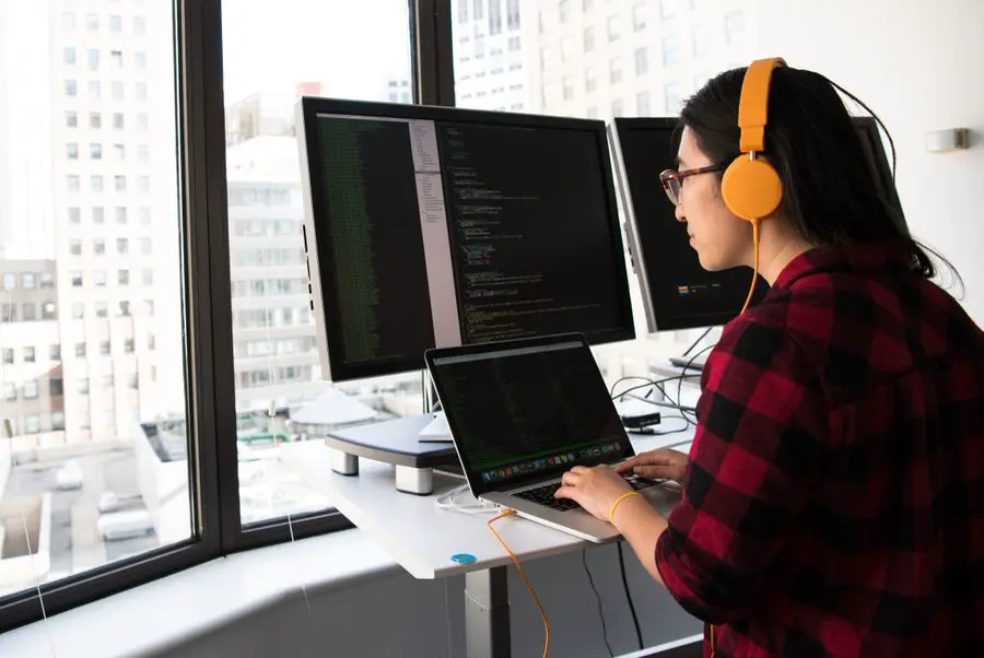 An engineer at a desk with two monitors
