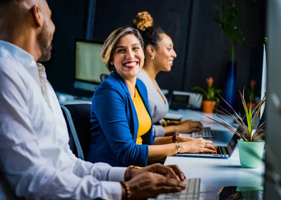 A designer smiling at her desk