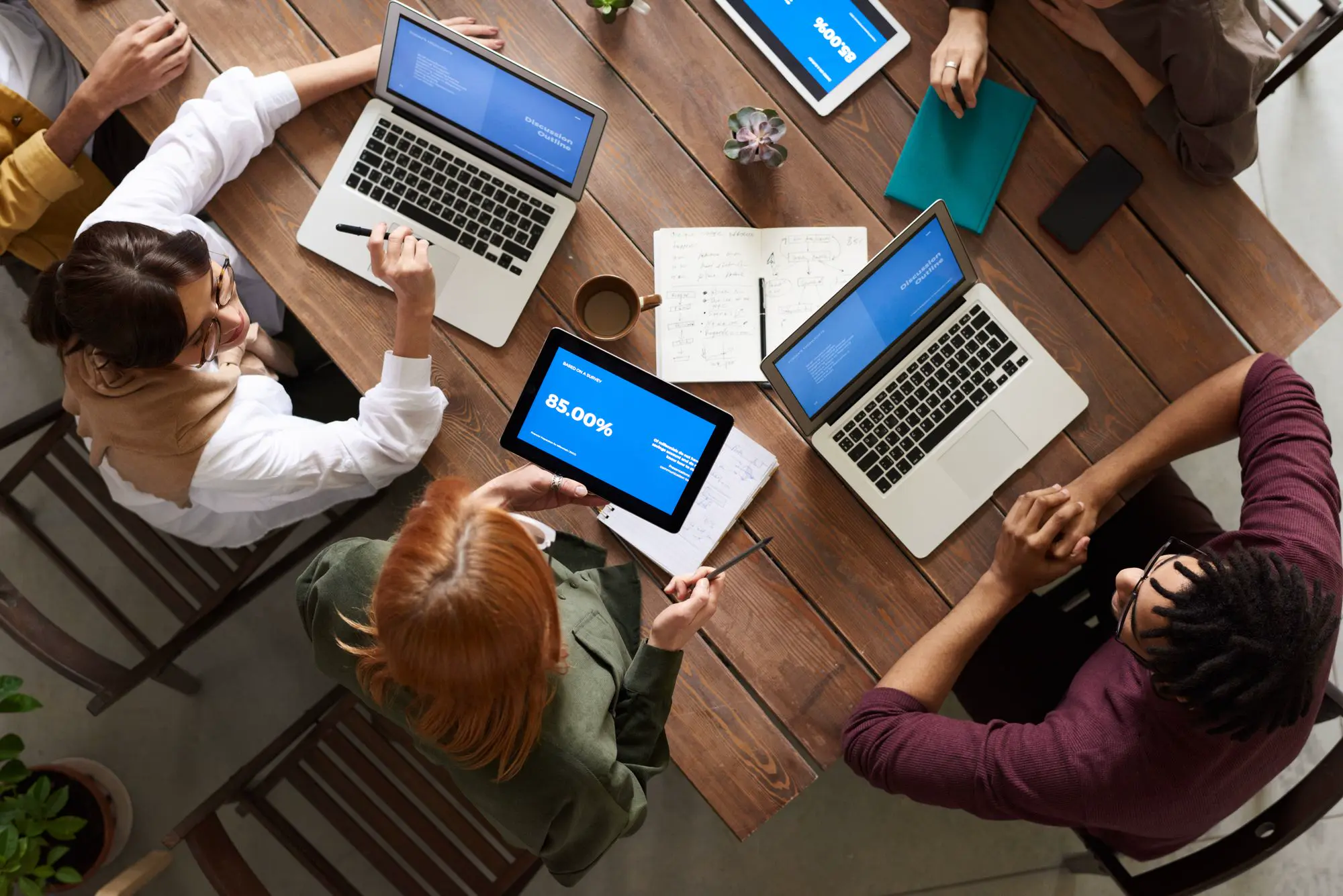 Team working together on laptops around a table